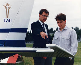 Greg Brown and Matthew Edwards inspecting the tail of a small aircraft