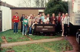 Students and staff posing with the Strombeck Library Sign