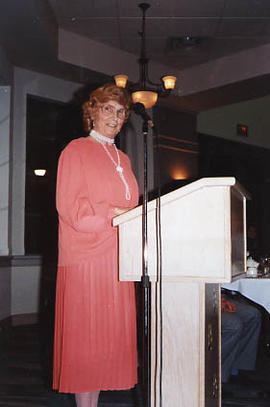 Speaker Vera Dowling standing at a podium