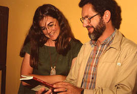 Two CanIl employees looking at a book together