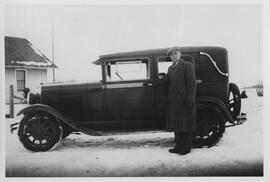 Robert Thompson standing in front of a car.