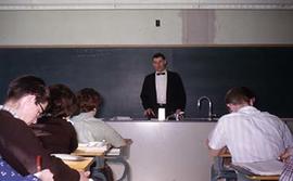 Chemistry faculty member A. Grohe teaching in front of students.