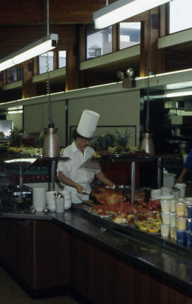 Chef preparing food in the Douglas Hall cafeteria.